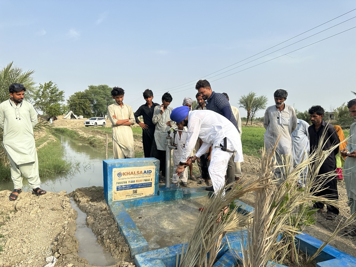 Hand Pump Installation 2022 - Community members using hand pump